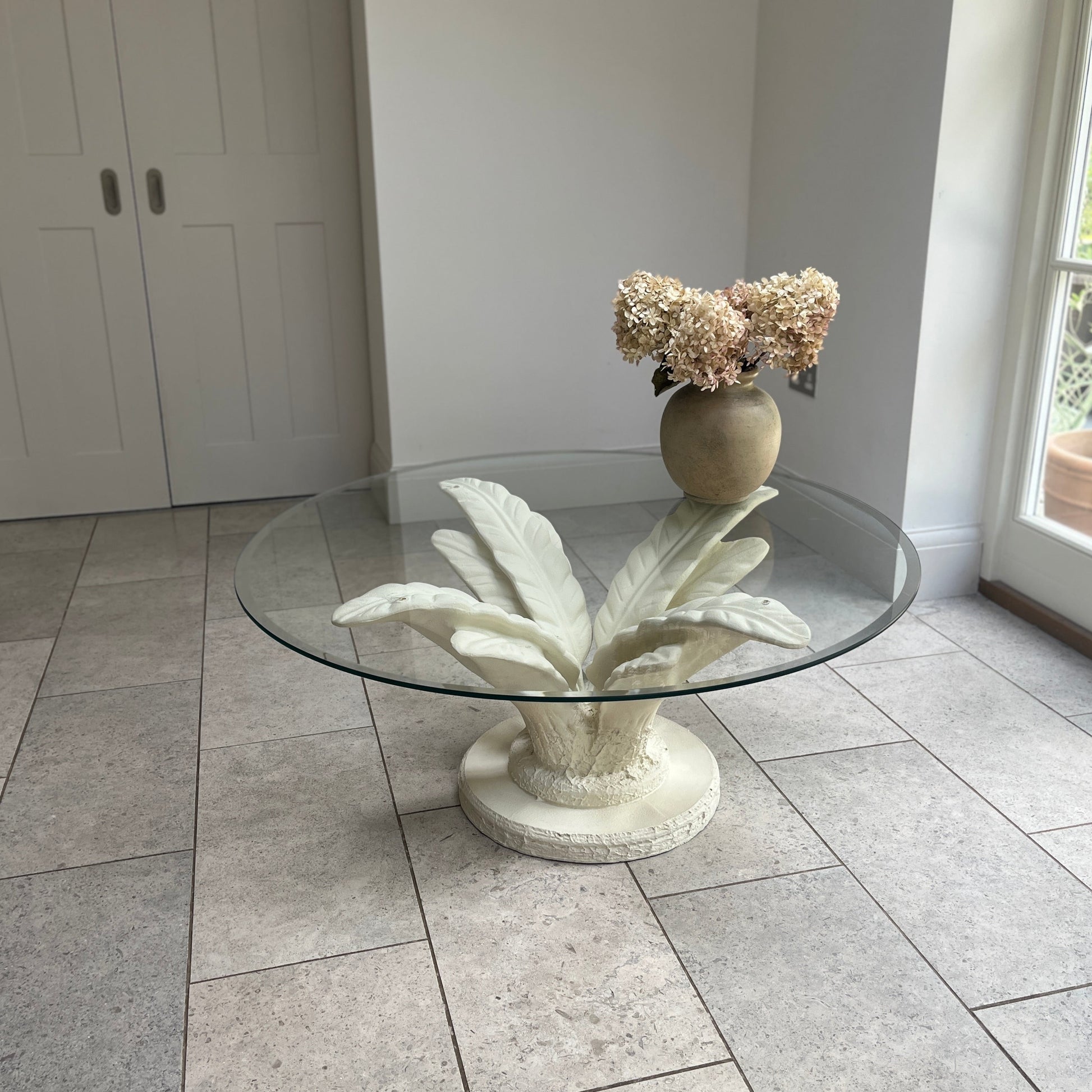 serge roche style vintage coffee table with plaster lea form base and round glass top